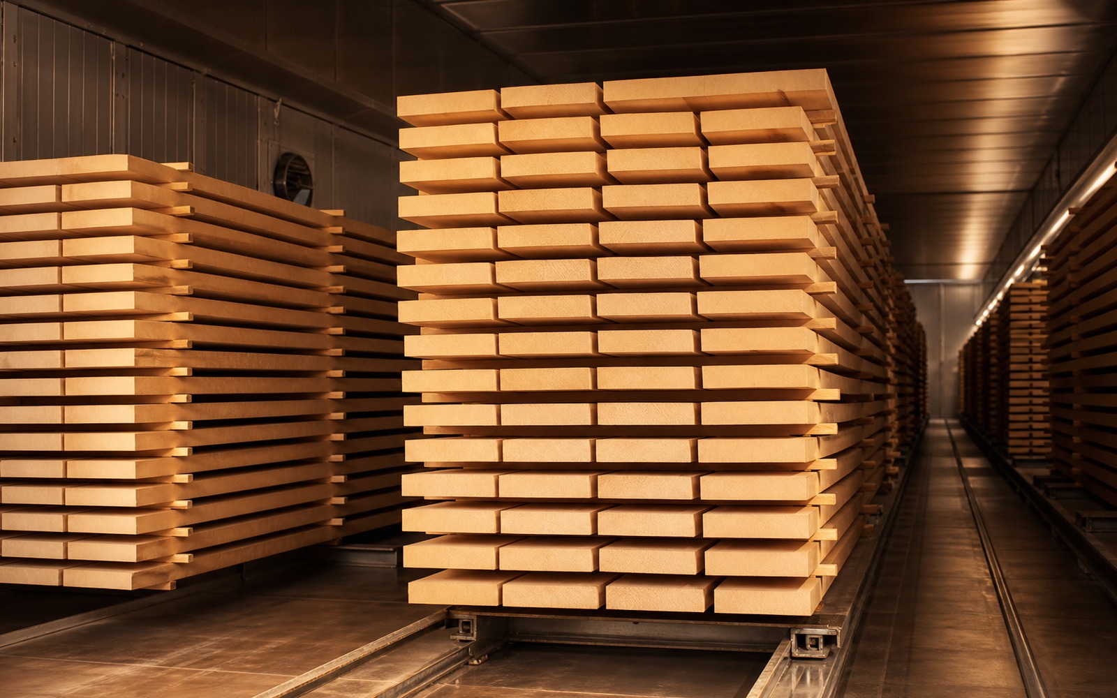 Stacked timber resting inside the drying kiln